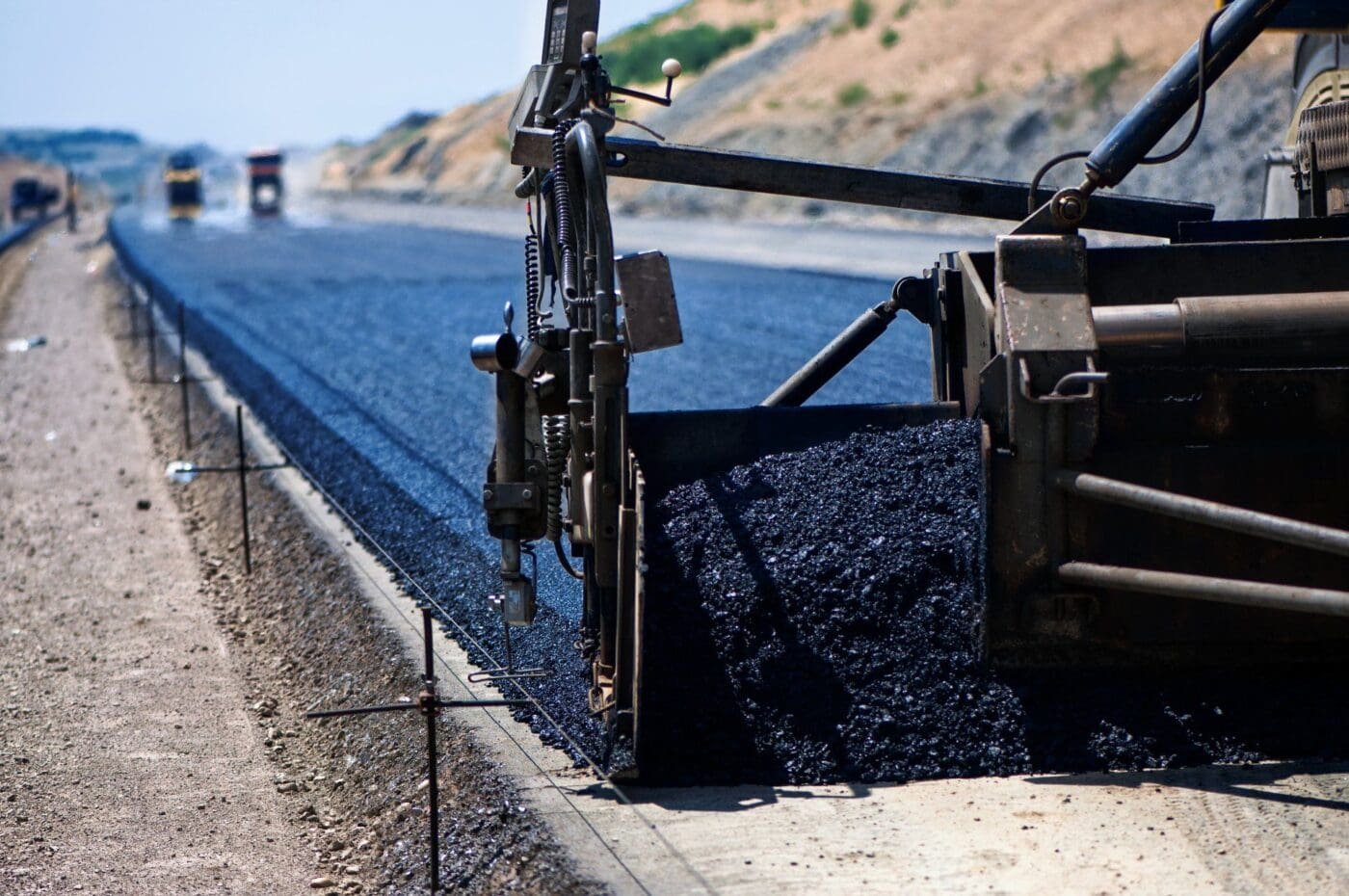 asphalt worker cutting asphalt road for a hot patch