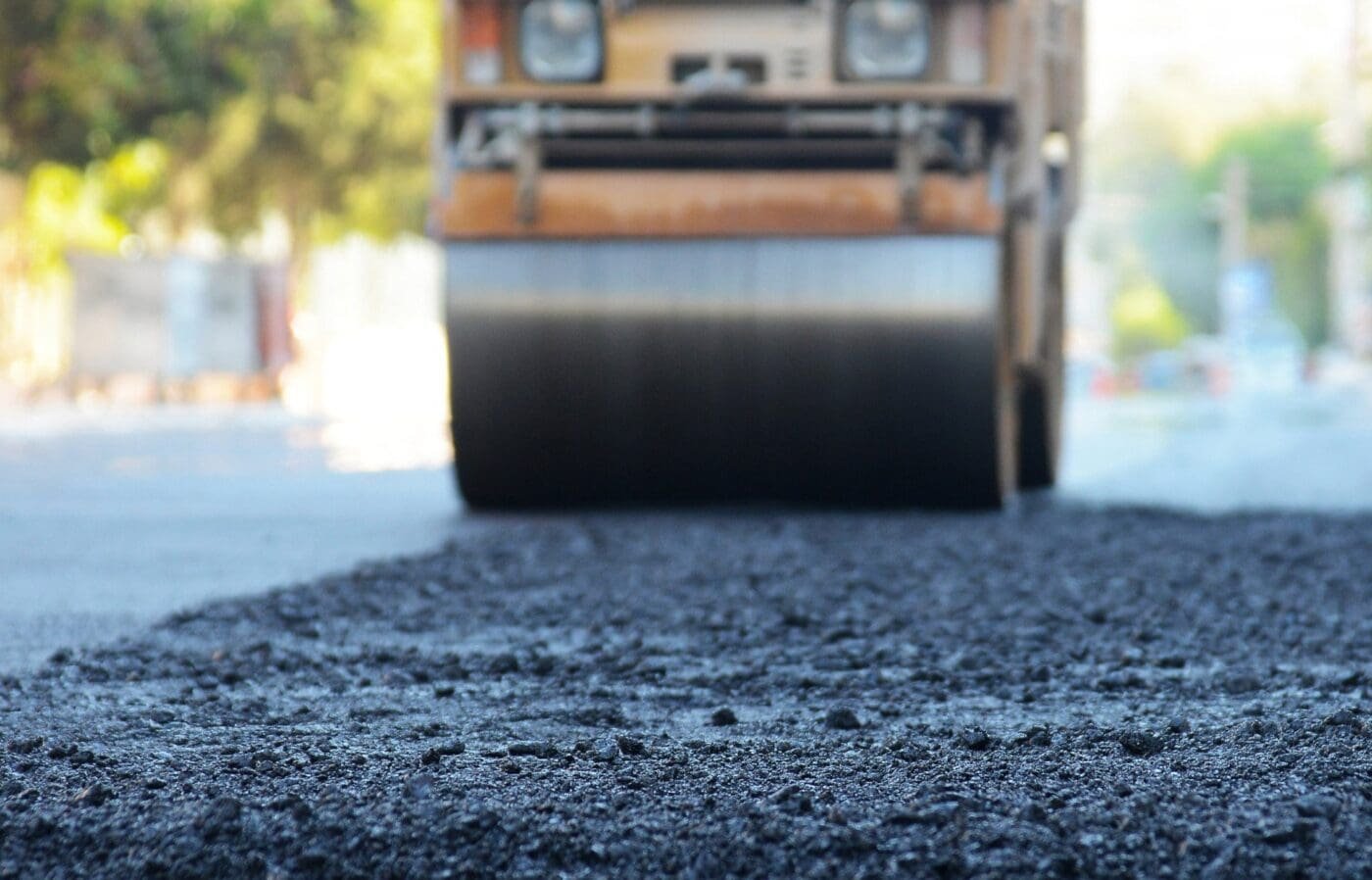 asphalt worker cutting asphalt road for a hot patch